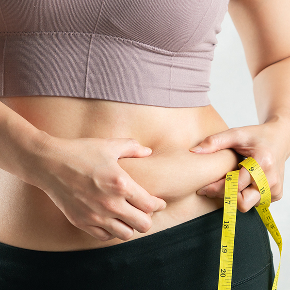 fat woman, fat belly, chubby, obese woman hand holding excessive belly fat with measure tape, woman diet lifestyle concept